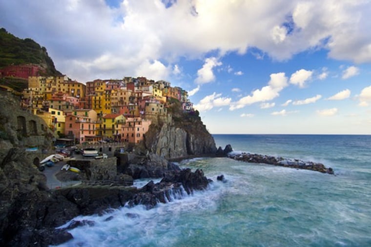 The buildings in the Cinque Terre town of Manarola add color to the rugged Italian coast.